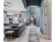 Open-concept living room with gray sectional flowing into the kitchen and hallway at 16220 Lake Armistead Way, Odessa, FL 33556