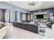 Bright living room with gray sectional sofa and entertainment center, with access to the patio at 16220 Lake Armistead Way, Odessa, FL 33556