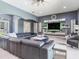 Comfortable open living area with sleek entertainment center and modern gray color scheme at 16220 Lake Armistead Way, Odessa, FL 33556