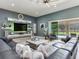 Open living area with a view of the pool, a large sectional, and modern decor at 16220 Lake Armistead Way, Odessa, FL 33556