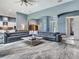 Expansive living room featuring gray sectional sofa and seamless transition to kitchen at 16220 Lake Armistead Way, Odessa, FL 33556