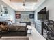 Modern main bedroom featuring tray ceiling, accent wall, and natural lighting at 16220 Lake Armistead Way, Odessa, FL 33556