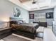 Modern main bedroom featuring tray ceiling, accent wall, and a luxurious style at 16220 Lake Armistead Way, Odessa, FL 33556