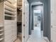Walk-in closet leading to en-suite bathroom with ample shelving and storage space at 16220 Lake Armistead Way, Odessa, FL 33556