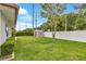 Spacious backyard featuring lush green grass and a storage shed at 1666 Souvenir Dr, Clearwater, FL 33755