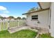 The backyard features a white privacy fence and a small outdoor patio at 1666 Souvenir Dr, Clearwater, FL 33755