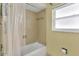 Bright bathroom features tiled walls, a shower, and a window for natural light at 1666 Souvenir Dr, Clearwater, FL 33755