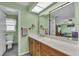 Bathroom featuring a long vanity with a door leading to the Primary bedroom at 1666 Souvenir Dr, Clearwater, FL 33755