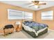 Bedroom featuring two large windows, a ceiling fan, and a metal bedframe at 1666 Souvenir Dr, Clearwater, FL 33755
