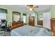 Bedroom featuring a ceiling fan, a dresser, and an ensuite bathroom at 1666 Souvenir Dr, Clearwater, FL 33755