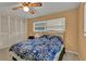 Bedroom featuring two large windows, a ceiling fan, and a spacious closet at 1666 Souvenir Dr, Clearwater, FL 33755