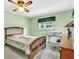 Cozy bedroom featuring a ceiling fan and a window letting in natural light at 1666 Souvenir Dr, Clearwater, FL 33755