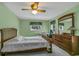 Spacious bedroom featuring a bed, dresser, and large windows at 1666 Souvenir Dr, Clearwater, FL 33755
