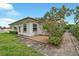Charming home exterior with a brick patio, well-kept lawn, and a small garden at 1666 Souvenir Dr, Clearwater, FL 33755