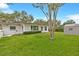 Charming exterior view of the home with a well-manicured lawn at 1666 Souvenir Dr, Clearwater, FL 33755