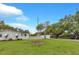 Exterior of home featuring a white picket fence, lush green lawn, and a well-maintained facade at 1666 Souvenir Dr, Clearwater, FL 33755
