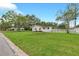 Charming single-story home with a white picket fence, and a spacious front yard at 1666 Souvenir Dr, Clearwater, FL 33755