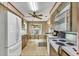 Bright kitchen has wood cabinets and white appliances; adjacent eat-in area at 1666 Souvenir Dr, Clearwater, FL 33755