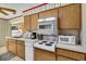 Kitchen featuring wood cabinets and modern appliances including a dishwasher and microwave at 1666 Souvenir Dr, Clearwater, FL 33755