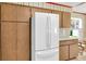 Kitchen features wood cabinetry and a new refrigerator for a modern look at 1666 Souvenir Dr, Clearwater, FL 33755