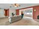 The living room features neutral paint, carpet, and a large window to maximize natural light at 1666 Souvenir Dr, Clearwater, FL 33755