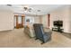 The living room features a front door, large windows, and an ceiling fan that provide ample natural light at 1666 Souvenir Dr, Clearwater, FL 33755