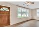 The living room features tile floors, large windows, and a wooden front door at 1666 Souvenir Dr, Clearwater, FL 33755
