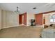 Inviting living room featuring carpet, a ceiling fan, and neutral tones at 1666 Souvenir Dr, Clearwater, FL 33755