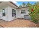 Tiled patio with outdoor seating area featuring a serene backyard and garden view at 1666 Souvenir Dr, Clearwater, FL 33755