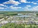 Beautiful aerial view of a community, featuring pristine landscaping, a lake, and well-maintained homes on a sunny day at 1696 Hidden Springs Dr, Trinity, FL 34655