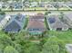 Aerial view of backyards with screened-in pools, and mature trees offering privacy, showcasing the desirable neighborhood at 1696 Hidden Springs Dr, Trinity, FL 34655