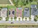 An aerial view shows well-maintained homes and swimming pools, landscaped yards, and an established neighborhood at 1696 Hidden Springs Dr, Trinity, FL 34655