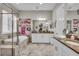 Bright bathroom featuring double vanity, soaking tub and frameless glass shower at 1696 Hidden Springs Dr, Trinity, FL 34655
