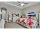 Comfortable bedroom featuring a floral quilt, ample natural light, and tasteful decor at 1696 Hidden Springs Dr, Trinity, FL 34655