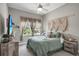 Bedroom featuring queen bed, neutral decor, and window views at 1696 Hidden Springs Dr, Trinity, FL 34655