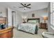 Bedroom with ceiling fan and decor, including a comfortable bed and nightstands with lamps at 1696 Hidden Springs Dr, Trinity, FL 34655