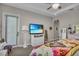 Relaxing bedroom featuring a TV, a large window and an open archway to the ensuite bathroom at 1696 Hidden Springs Dr, Trinity, FL 34655