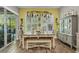 Dining room with natural light, casual seating, and a view of the outdoor pool area at 1696 Hidden Springs Dr, Trinity, FL 34655