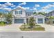 Charming two-story home with a well-maintained lawn, two-car garage, and beautiful landscaping under a partly cloudy sky at 1696 Hidden Springs Dr, Trinity, FL 34655