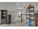 Hallway boasts carpet, storage shelving, and leads to staircase and other rooms at 1696 Hidden Springs Dr, Trinity, FL 34655