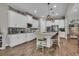 Bright and spacious kitchen featuring white cabinets, modern appliances, a center island, and stylish pendant lighting at 1696 Hidden Springs Dr, Trinity, FL 34655