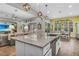 A kitchen with an island and granite countertops overlooks the living area at 1696 Hidden Springs Dr, Trinity, FL 34655