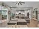Cozy living room with a comfortable gray sectional and open view into the kitchen at 1696 Hidden Springs Dr, Trinity, FL 34655