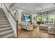 Open living room featuring hardwood floors, a ceiling fan, and sliding glass doors to the pool area at 1696 Hidden Springs Dr, Trinity, FL 34655