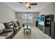 Comfortable living room area with large windows, a ceiling fan, and media center at 1696 Hidden Springs Dr, Trinity, FL 34655