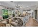 Bright living room featuring a large sectional sofa, stylish decor, and view of the pool at 1696 Hidden Springs Dr, Trinity, FL 34655