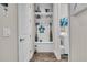 Mudroom featuring white bench with hooks and shelving, as well as access to the laundry room at 1696 Hidden Springs Dr, Trinity, FL 34655