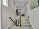 Carpeted staircase with wooden railings leads to the upper level, showcasing a view of the open hallway at 1696 Hidden Springs Dr, Trinity, FL 34655