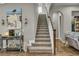Carpeted staircase with white railings and wooden trim, leading to the upper level of the home at 1696 Hidden Springs Dr, Trinity, FL 34655