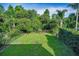 View of the fenced in backyard featuring lush landscaping providing privacy at 1712 Crossvine Ct, Trinity, FL 34655